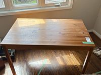Full view of wooden table top and legs