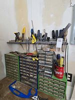 overall view of drawer cabinets, shelf of tools and tin