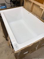 Top view of white acrylic bathtub in carton