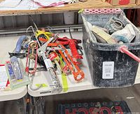 tabletop with multiple caulking guns and bin of floats