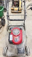Full view of Craftsman mower showing deck, handle, and wheels