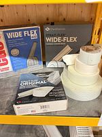 Boxes of Strait-Flex Wide-Flex, CGC Wide Flex 400, loose fiberglass mesh tape rolls