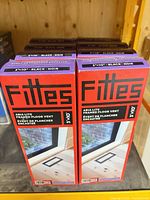 Front view of six boxed Fittes Aria Lite floor vents on shelf