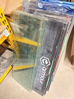 Stack of glass panels leaning against shelving next to stair tread protector