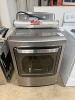 Front view of LG dryer with duct on top