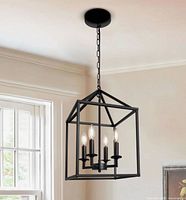 Marketing photo of assembled black matte Savoy House 4-light pendant hanging from ceiling