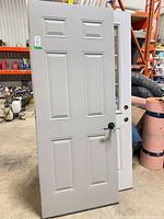 Full view of gray metal 6-panel door with black lever handle