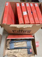 Six red Aria retail boxes plus one opened kit showing metal brackets