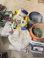 Overview of assorted clips, wedges, nails and containers