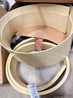 Curved sleeve and narrow ring nested together in box