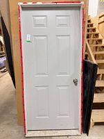 front view of grey 6-panel steel door within prehung frame