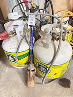 Two Tank Traders propane cylinders with torch and hoses visible