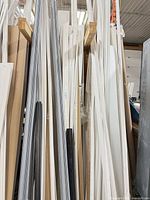 Full view of assorted PVC trim and siding pieces standing vertically