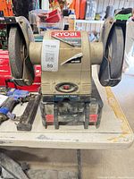 Front view showing both grinding wheels, housing and label