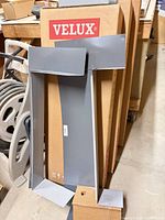 Grey metal flashing pieces leaning against Velux boxes