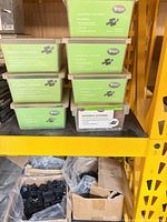 Six Trex Universal Fastener kits in clear bins, bulk clips box below