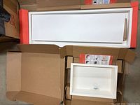 Two long white vent covers and one smaller niche inside original boxes
