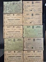 Ten ration booklets laid out showing covers
