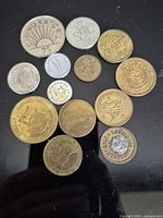 Overview of all 13 tokens on black surface