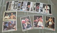 All 18 All World boxing cards laid out, showing fronts including three Ali Bonus cards and other fighters