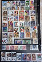 Front view of all 64 Canadian Christmas stamps arranged on a black background