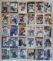Overview of all 30 Curtis Joseph hockey cards laid out in protective sheet