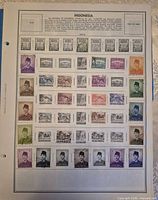 First album page showing multiple coloured and monochrome Indonesian stamps