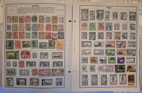 Two album pages filled with Jamaican stamps, diverse designs