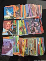 Stack and spread of The Lion King trading cards