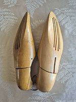 Pair of wooden hinged shoe forms side by side