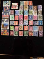 Grid layout of 50 different used Great Britain postage stamps