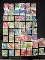 Array of 50 used Denmark stamps displayed on black background