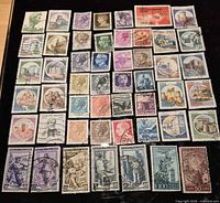 Array of 50 different Italian postage stamps laid out for view