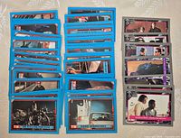 Front view of stacked blue-border stickers and grey-border cards