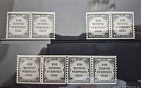 Front view of three test coil stamp pieces: two pairs and one strip of four
