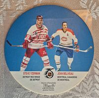 Front of round Kraft Peanut Butter hockey disc displaying images of Steve Yzerman and Jean Beliveau with team names and Kraft logo