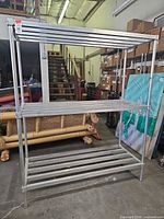 Full view of first aluminum shelving unit, three shelves