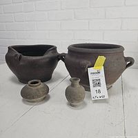 Group shot of two large brown slouch pots and two small grey vessels