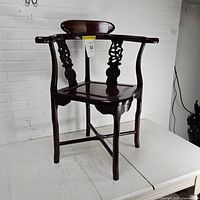 Full view of Chinese carved wood corner chair showing overall structure