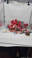 Full lot overview in lightbox showing wreath, boxed ornaments, tray and assorted pieces