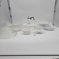 Full group of Corning Ware pieces with lids displayed