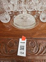 Front view showing butter dish with lid and surrounding glassware