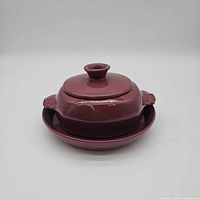 Casserole with lid resting on serving dish