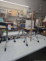 Three stands and drum throne displayed on table