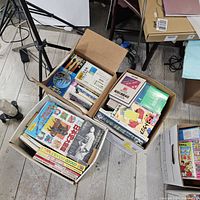 Overhead view of three boxes filled with Japanese books