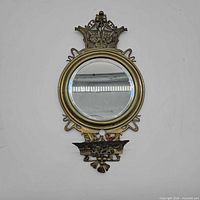Front view of ornate round mirror with decorative metal frame