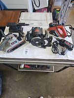 Group shot showing all five corded power tools on table