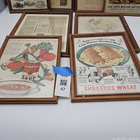 Five framed ads including Campbell’s and Shredded Wheat with three additional frames partially visible