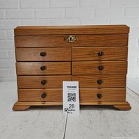 Front view of oak-finish jewelry chest closed