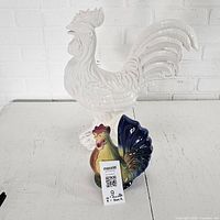 Front view of both rooster figurine and chicken coin bank